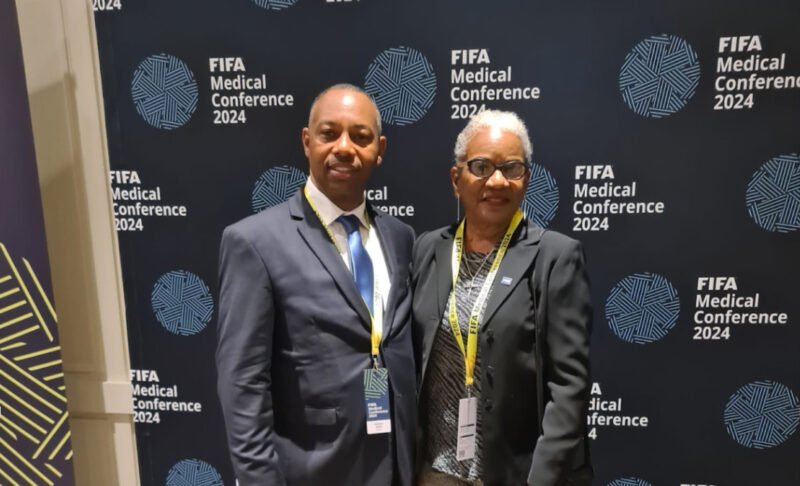 Standing in unity, Daniel Miller and Dr. Patti Symonette exemplify the Bahamas' commitment to advancing football healthcare at the FIFA Medical Conference 2024.