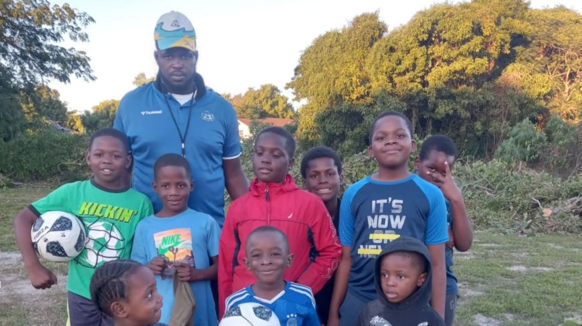 Community Unity Through Soccer: Coach Romario West, Youth Training Officer, BFA, with young aspiring players at the Uriah McPhee playing field, as part of the BFA and Urban Renewal's new engagement program.